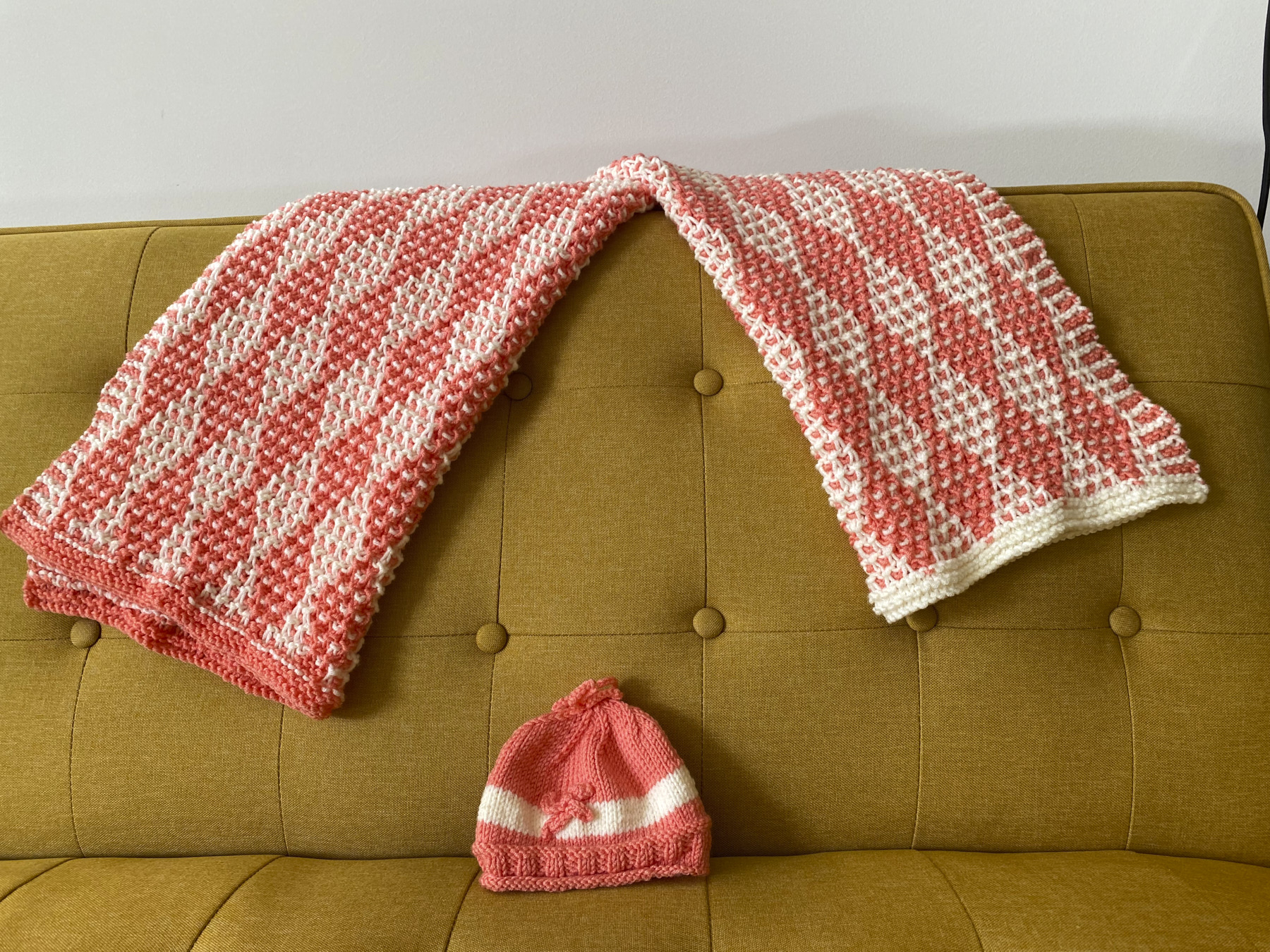 Two blankets with reversed colors and hat