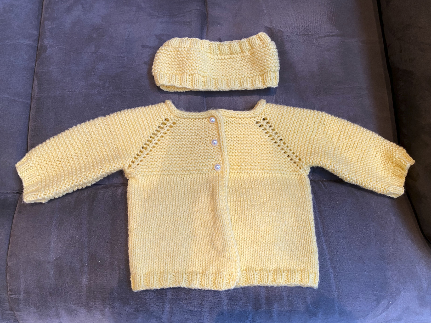 Front of Kay's yellow baby sweater and head band