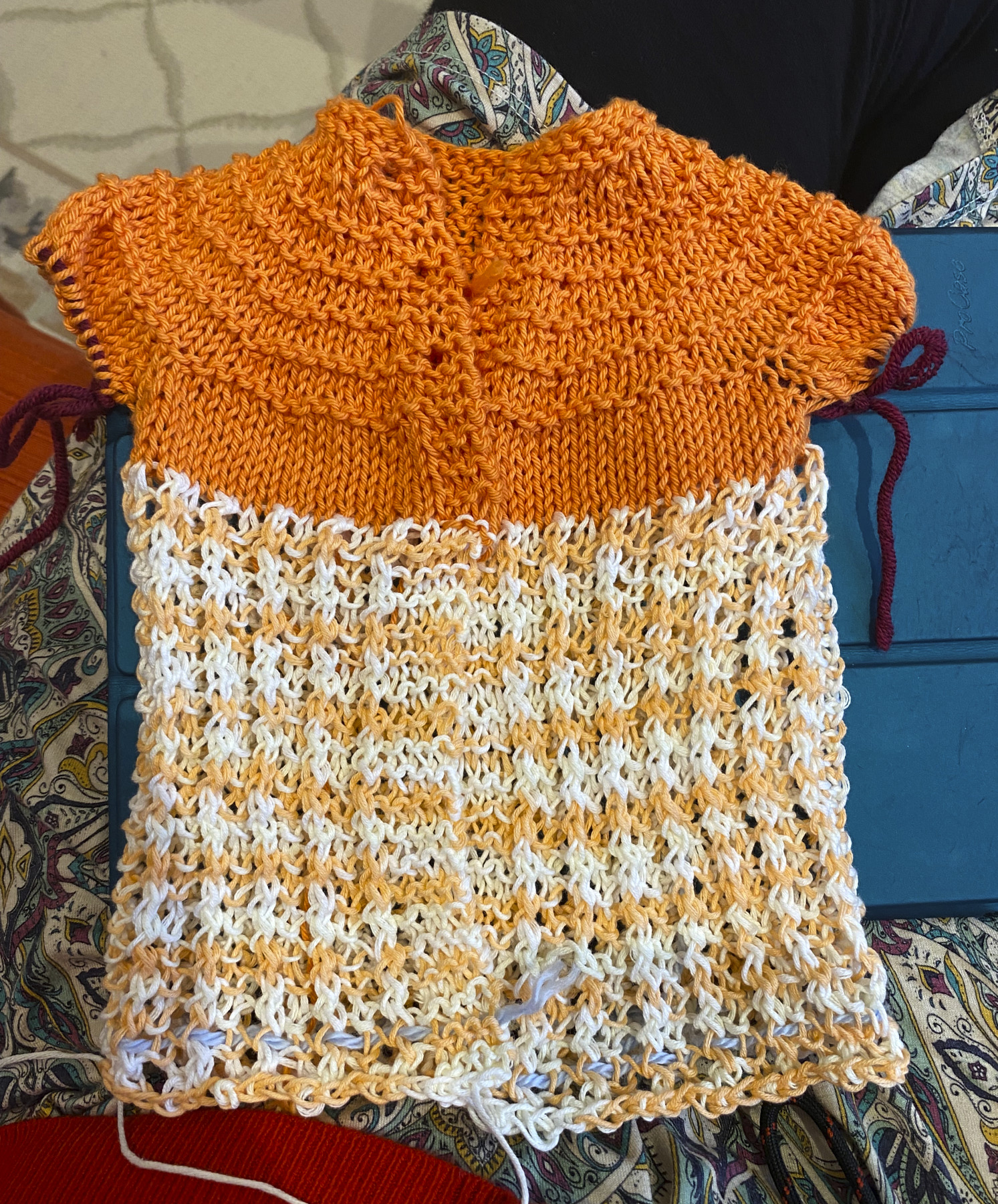 Front lacy baby sweater done in orange