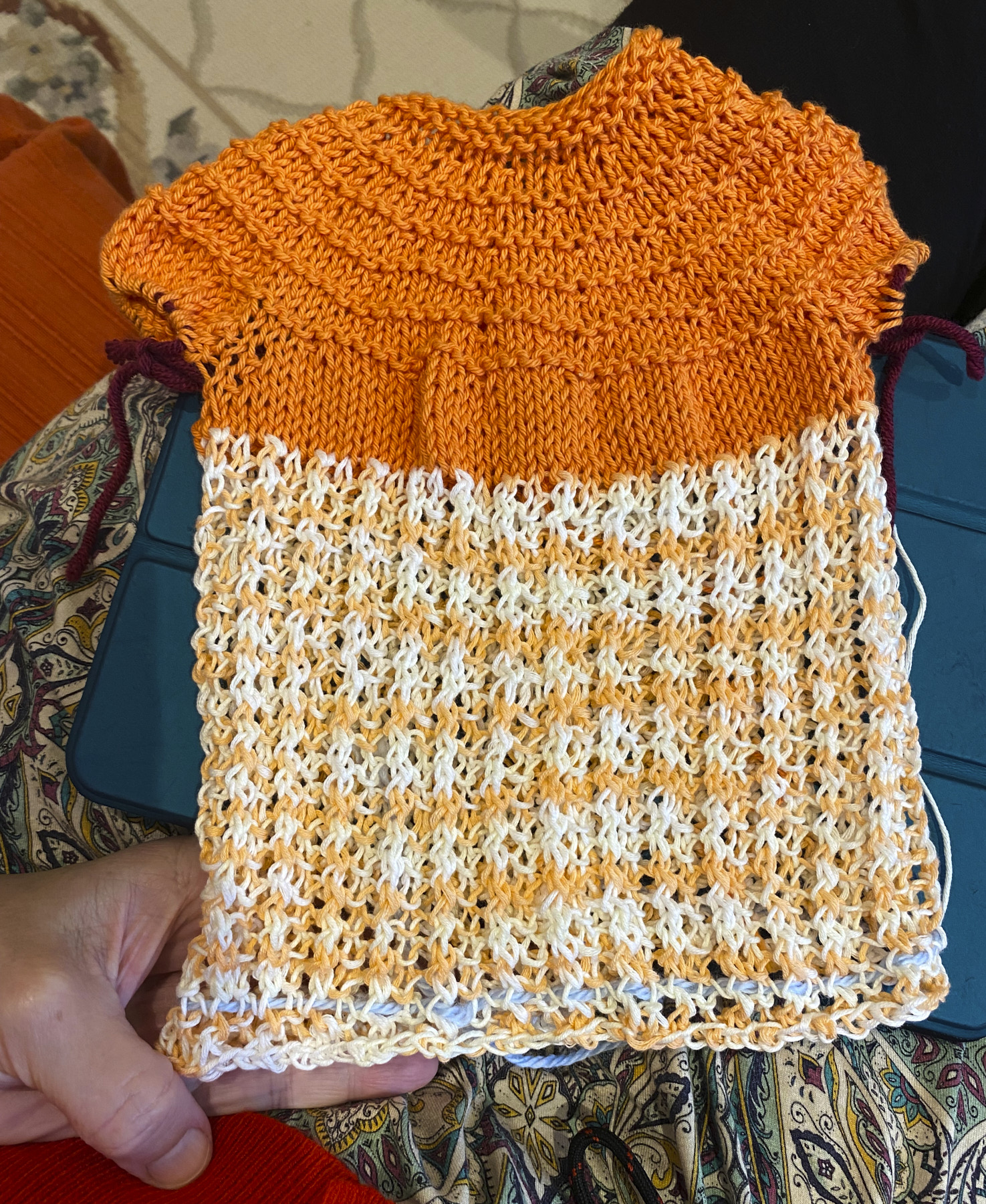 Lacy baby sweater done in orange